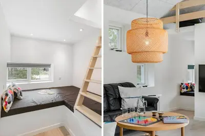 a tiny house with a loft bed and a desk at BL1367-Blokhus-Saetergaardsstien-12 in Blokhus