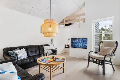 a living room with a couch and a table at BL1367-Blokhus-Saetergaardsstien-12 in Blokhus