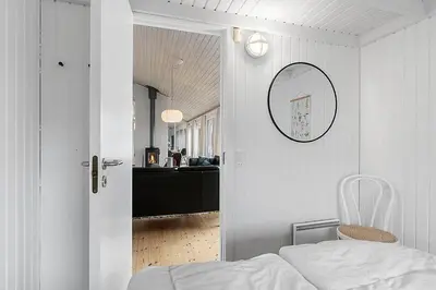 a bedroom with a bed and a mirror on the wall at BL738-Saltum-Graabakken-53 in Saltum