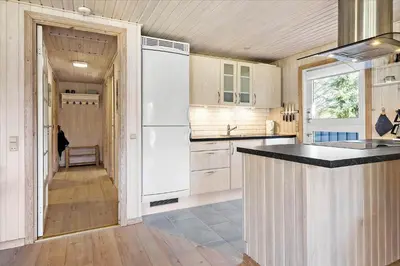 a kitchen with a white refrigerator and a counter at BL1361-Saltum-Jaerens-Rev-Sydvest-8 in Saltum