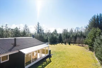 a house with a large yard next to a forest at BL1361-Saltum-Jaerens-Rev-Sydvest-8 in Saltum