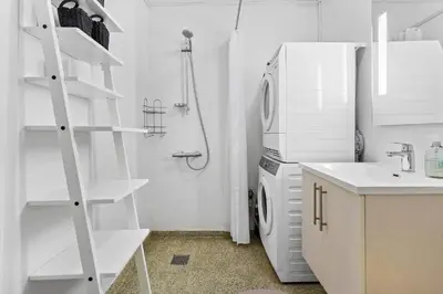 a white kitchen with a refrigerator and a sink at BL1584-Blokhus-Strandvejen-14-Lejl-4 in Blokhus