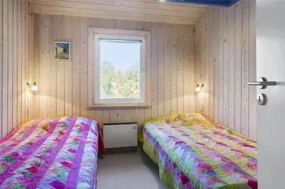 a bedroom with two beds and a window at BL1720-Saltum-Kvansletten-27 in Saltum