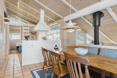 a kitchen and dining room with a wooden table and chairs at BL343-Saltum-Raabukvej-24 in Saltum