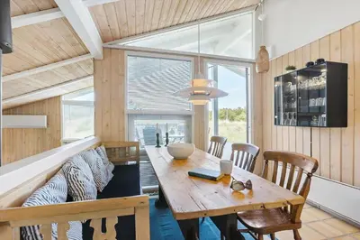 a dining room with a wooden table and chairs at BL343-Saltum-Raabukvej-24 in Saltum