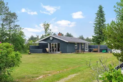 a small blue house with a yard in front of it at BL1487-Saltum-Brune-Banke-7 in Saltum