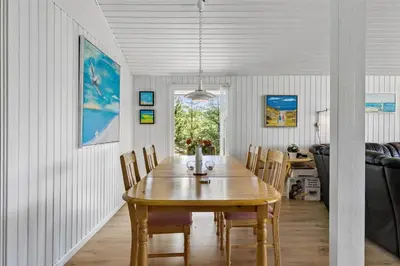 a dining room with a wooden table and chairs at BL317-Saltum-Kalundborgvej-1 in Saltum