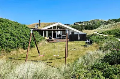 a house on a hill with swings in the yard at BL317-Saltum-Kalundborgvej-1 in Saltum