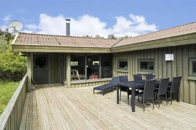 a patio with a table and chairs on a deck at BL1714-Saltum-Lyngsletten-11 in Saltum