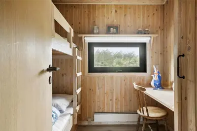 a tiny house with a window and bunk beds at BL1714-Saltum-Lyngsletten-11 in Saltum