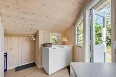 a kitchen in a tiny house with a counter at BL1374-Saltum-Sydvestpassagen-8 in Saltum