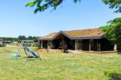 a house with a playground in front of it at BL1491-Saltum-Laustvej-10 in Saltum
