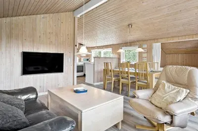 a living room with a couch and a table at BL286-Blokhus-Bag-Hojen-31 in Blokhus