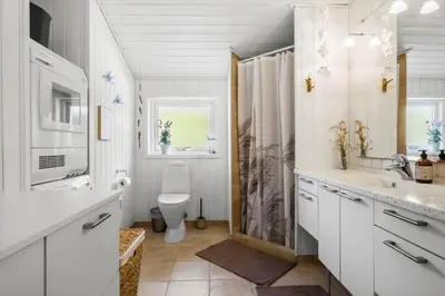 a bathroom with a toilet and a sink at BL1247-Blokhus-Skraavejen-24 in Blokhus