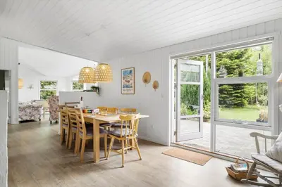 a kitchen and dining room with a table and chairs at BL1247-Blokhus-Skraavejen-24 in Blokhus