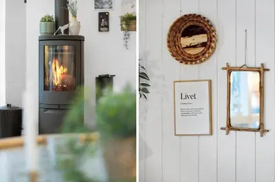 a living room with a fireplace and a mirror at BL1247-Blokhus-Skraavejen-24 in Blokhus