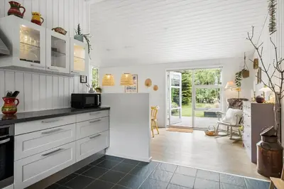 a kitchen with white cabinets and a counter top at BL1247-Blokhus-Skraavejen-24 in Blokhus