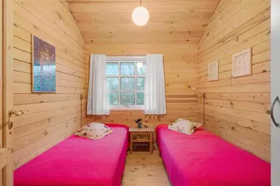 two red beds in a room with a window at BL1788-Blokhus-Gyvelvej-21 in Blokhus