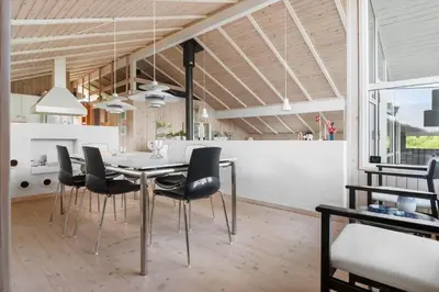 a dining room and kitchen with a table and chairs at BL177-Saltum-Kvansletten-23 in Saltum