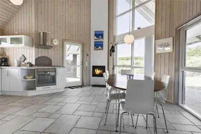 a kitchen and dining room with a table and chairs at BL1357-Blokhus-Ved-Stranden-2 in Blokhus