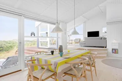 a dining room with a yellow table and chairs at BL832-Saltum-Kohlsvej-8 in Saltum