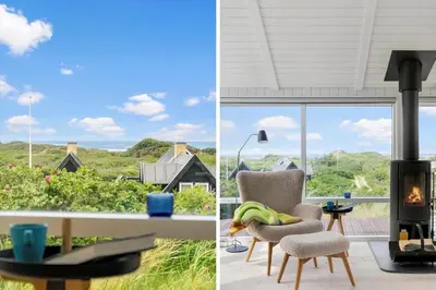 a living room with a fireplace and a view of a house at BL832-Saltum-Kohlsvej-8 in Saltum