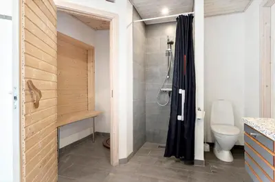 a bathroom with a shower and a toilet at BL381-Blokhus-Maxvej-4 in Blokhus