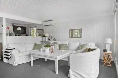 a living room with a white couch and a table at BL1467-Saltum-Solmarken-4 in Saltum