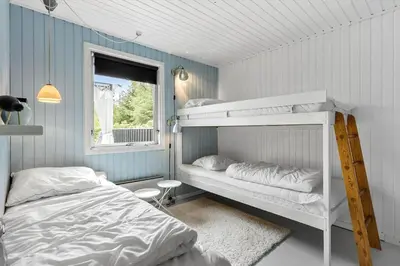 a bedroom with two bunk beds and a window at BL1467-Saltum-Solmarken-4 in Saltum