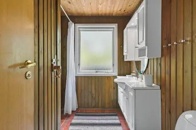 a bathroom with a white sink and a window at BL1467-Saltum-Solmarken-4 in Saltum