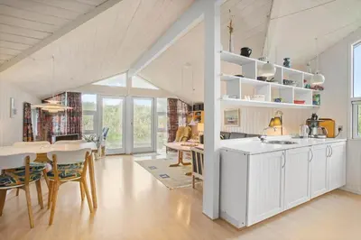 a kitchen and dining room with a table and chairs at BL1558-Saltum-Opossumvej-20 in Saltum