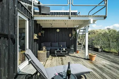 a deck with a table and chairs on a house at BL1746-Saltum-Kalundborgvej-23 in Saltum