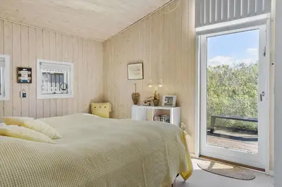 a bedroom with a bed and a large window at BL1746-Saltum-Kalundborgvej-23 in Saltum