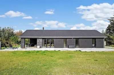 a small building with a grass field in front of it at BL1442-Blokhus-Bag-Hojen-43 in Blokhus