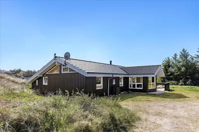 a small house on the side of a hill at BL1751-Blokhus-Wolundsvej-4-A in Blokhus