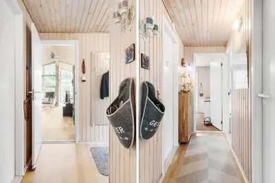 a hallway with a pair of shoes hanging on the wall at BL1213-Pandrup-Rodhusparken-14 in Pandrup