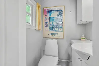 a bathroom with a white toilet and a sink at BL554-Blokhus-Kragebak-2 in Blokhus