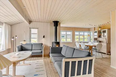 a living room with a couch and a table at BL220-Blokhus-Bakkevaenget-9 in Blokhus
