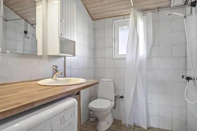 a bathroom with a toilet and a sink and a shower at BL758-Pandrup-Hunetorp-Klitvej-237 in Pandrup