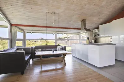 a kitchen and living room with a couch and a table at BL758-Pandrup-Hunetorp-Klitvej-237 in Pandrup