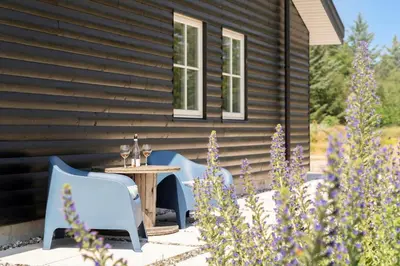 a patio with a table and chairs in front of a house at BL1559-Saltum-Nordvestvej-25 in Saltum