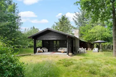 a log cabin with a patio in the grass at BL1494-Saltum-Viborgvej-6 in Saltum