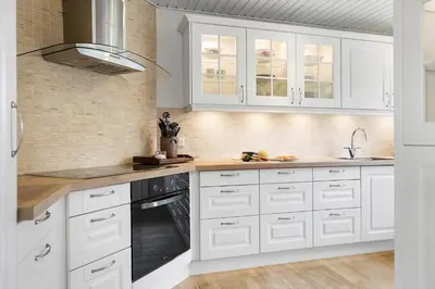 a white kitchen with white cabinets and a sink at BL1206-Blokhus-Blaabaervej-6 in Blokhus