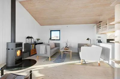 a living room with a couch and a fireplace at BL1529-Pandrup-Ferborgvej-58 in Pandrup