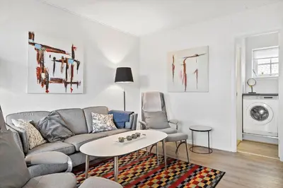 a living room with a couch and a table at BL1260-Blokhus-Strandvejen-14-Lejl-9 in Blokhus