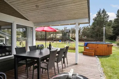 a patio with a table and chairs on a deck at BL1781-Saltum-Ornebjergvej-26 in Saltum