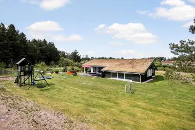 a yard with a house and a playground at BL1781-Saltum-Ornebjergvej-26 in Saltum