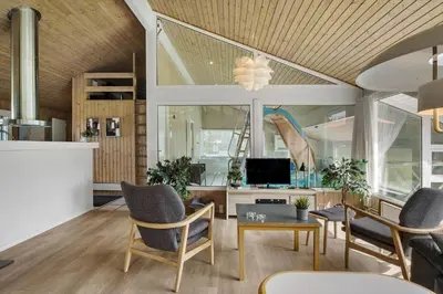 a living room with a table and chairs and a television at BL1781-Saltum-Ornebjergvej-26 in Saltum