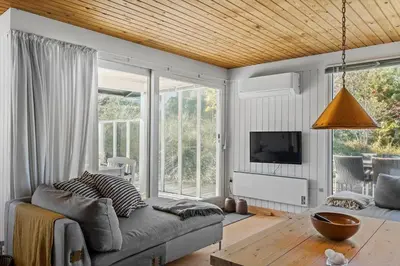 a living room with a couch and a tv at BL1677-Saltum-Sikahjortvej-6 in Saltum