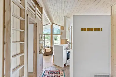 a hallway with a door leading to a kitchen at BL1700-Blokhus-Bloksbjerg-55 in Blokhus